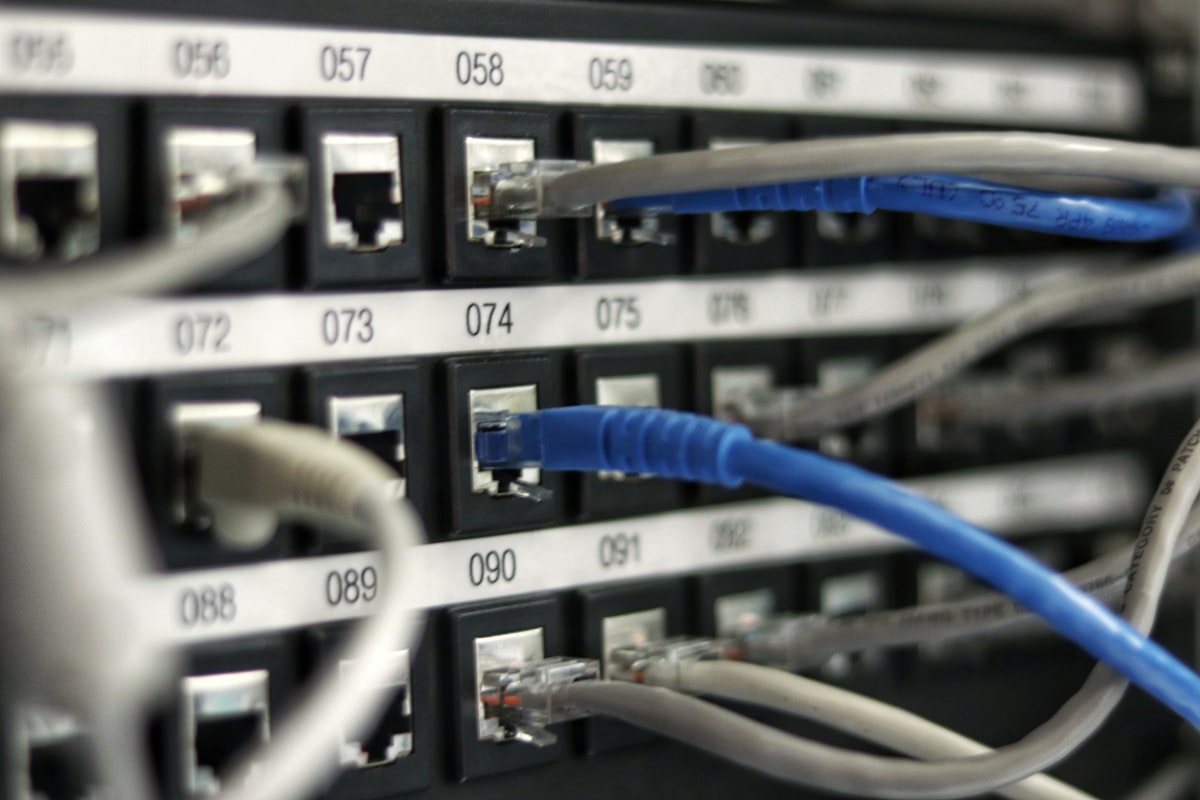 Enterprise server room with illuminated rack rows and orange status LED accents, viewed from above